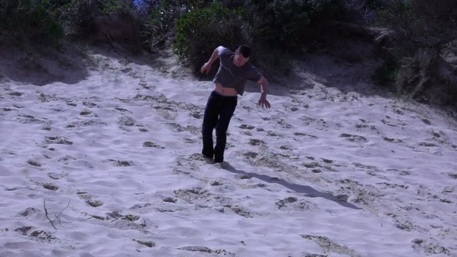 Boy Performs a somersault on the beach, slow motion