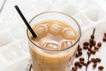 Ice coffee with milk and beans for lunch on white background