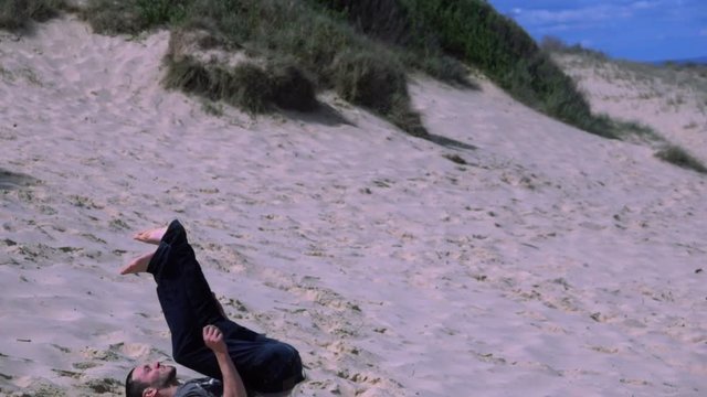 Boy Performs a somersault on the beach, slow motion