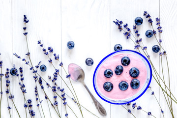 lavender flowers with blueberry yoghurt mock up on white background top view
