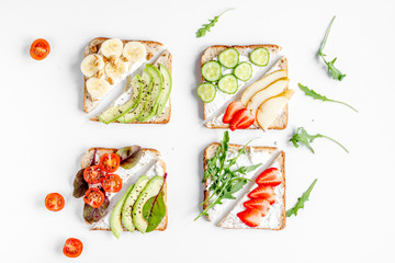 homemade sandwiches composition on white table background top view