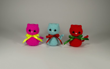 Little Knitted multicolored kitten with a bow. Handmade. Toy