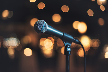 Microphone on stage against a background concert or show.