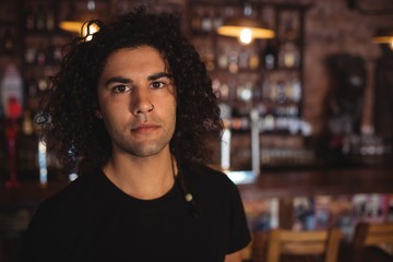 Portrait of man standing in pub