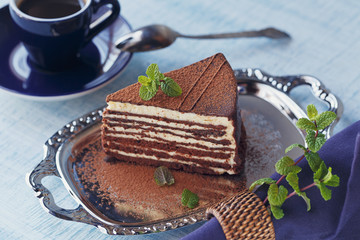Slice of delicious chocolate cake on silver plate