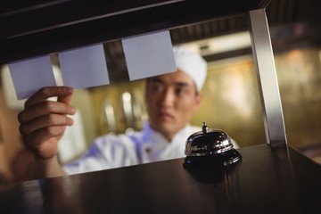 Chef looking at an order list in the commercial kitchen