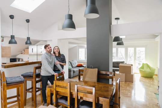 Lovely Young Couple Smiling In Their New Apartment Home