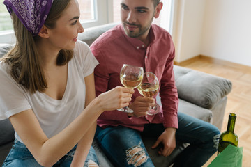 Young couple toasting with white wine