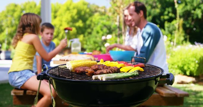 Grilling meat and vegetables on barbecue