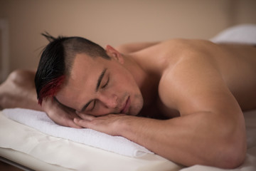 Fototapeta na wymiar handsome man resting in a spa massage center
