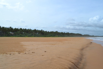 Indian ocean with golden sand, Bentota, Sri Lanka. A wonderful nature landscape of a beach scene.