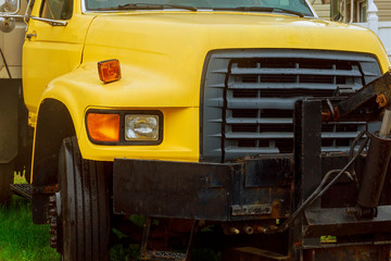 Close up front view of yellow truck,