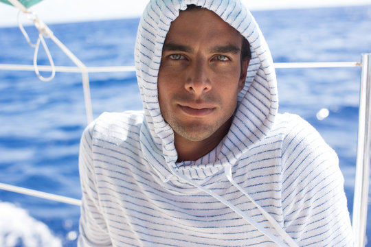 Man on boat with hood up, Tahiti, South Pacific