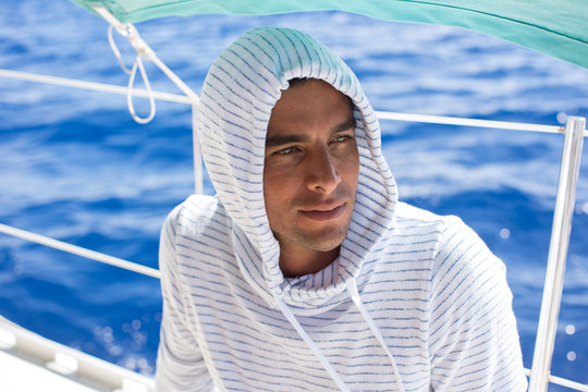 Man on boat, shaded by canopy, Tahiti