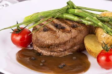 Close up on filet mignon with vegetables on the side