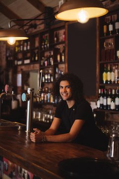 Male bar tender at bar counter