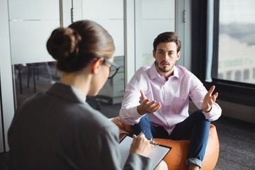 Counselor consoling unhappy man