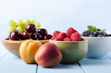 Fresh Fruit Choices in Bowls on Light Blue Wood Planked Table