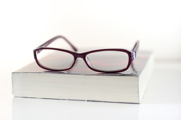 Education,Book and glasses on white background