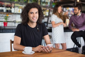 Portrait of young man holding mobile phone 
