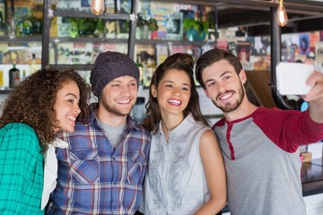 Young man taking selfie with friends