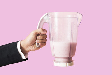 Hand holding healthy smoothie drink 