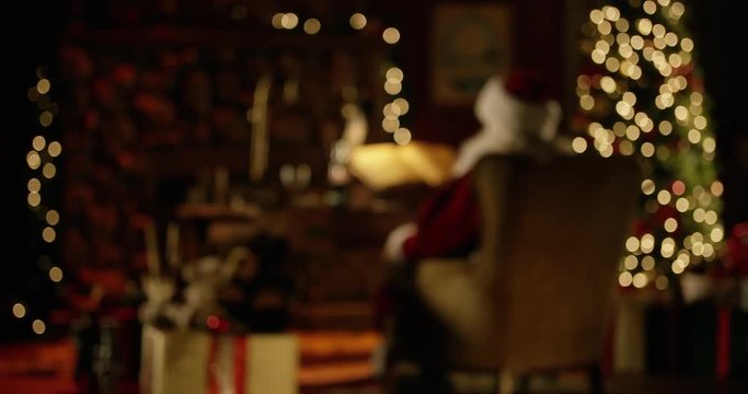 Santa Claus sitting in North Pole workshop at Christmastime; magical/traditional