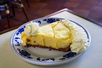 A slice of key lime pie with whipped cream on a plate 