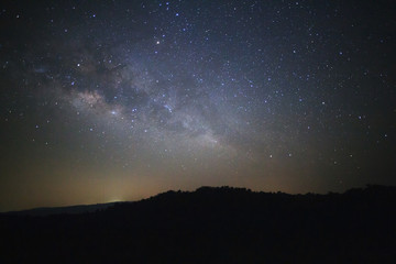 Obraz na płótnie Canvas Milky way galaxy with stars over moutain at Phu Hin Rong Kla National Park,Phitsanulok Thailand, Long exposure photograph.with grain