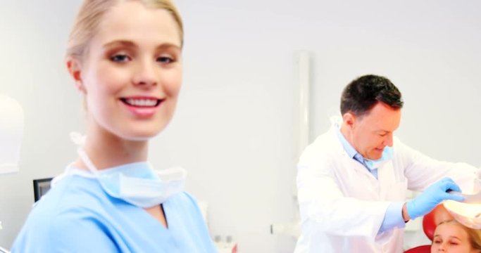 Portrait of smiling nurse standing in clinic
