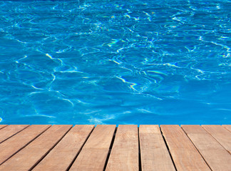 Fototapeta na wymiar piscine bleue et plage bois