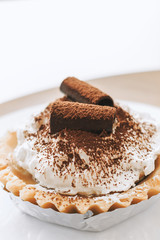 closeup banoffee pie with soft-focus in the background. over light and old film colors tone