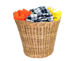 Colorful clothes in basket isolated on white