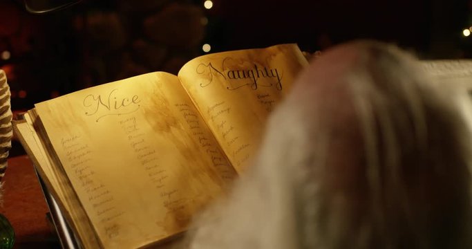Santa Claus makes final adjustments to his list with a quill pen.