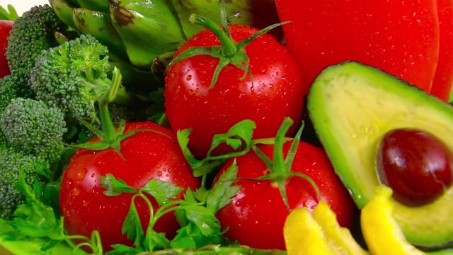 Beautiful vegetables rotating on white background