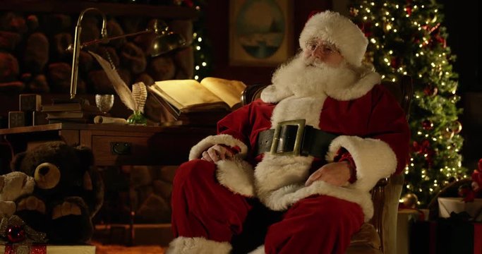 Santa glances back at Naughty/Nice Christmas list in North Pole workshop