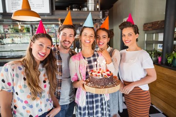Cheerful friends celebrating birthday at restaurant