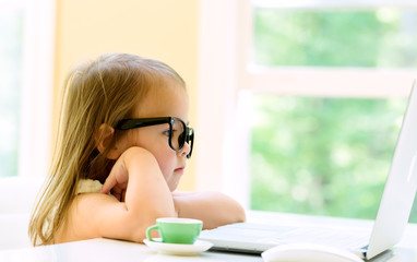 Little girl with her laptop computer