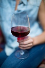 Woman holding red wine glass