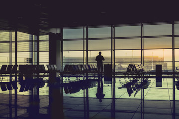 Silhouette passenger at the airport terminal during sunrise. Travel Concept. Vintage colors