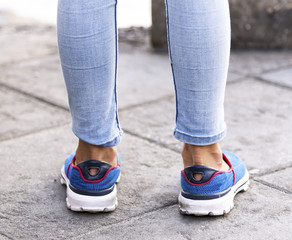 Fototapeta na wymiar Girl leg blue jean and blue shoe