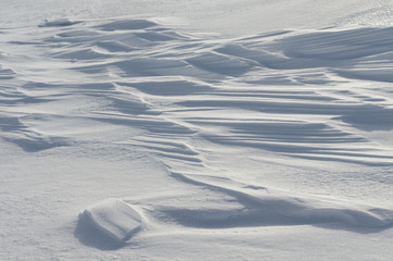 Snow like waves frozen from the winter winds.