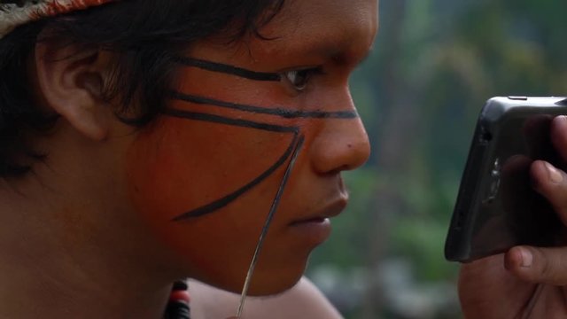 Native Brazilian Man (Indio) Painting on his Face in a Indigenous Tribe