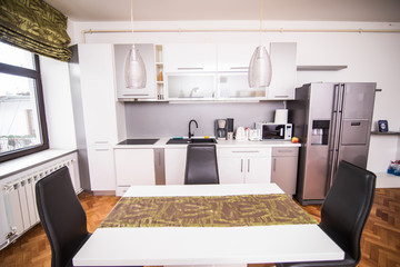 Chairs and table and kitchen in a dining room
