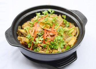 Sauteed pork in black stew with chili, onion and herbs