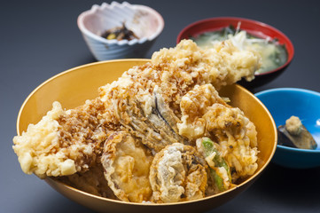 Fried tempura of shrimp and vegetables in bowl in black background