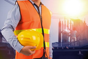 engineer holding protection equipment on site  background