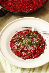 Red tomatoes sauce with minced herbs on white platter