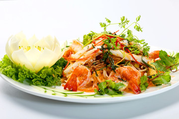 Seafood salad with shrimp, squids lettuce, mint leaves and herbs on white dish