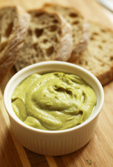 Bean pate with bread on wooden cutting board